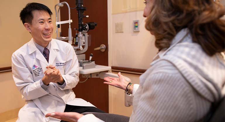 Image of doctor talking to female patient